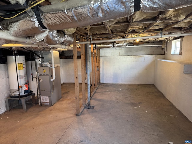 basement featuring gas water heater and heating unit