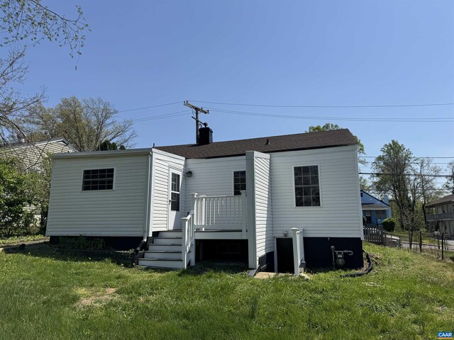 rear view of property with a wooden deck and a chimney