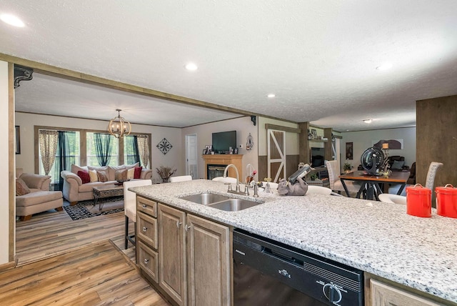 2749 Lee Hwy E, New Market, VA 22844 - kitchen featuring dishwasher, open floor plan, light wood finished floors, a glass covered fireplace, and a textured ceiling