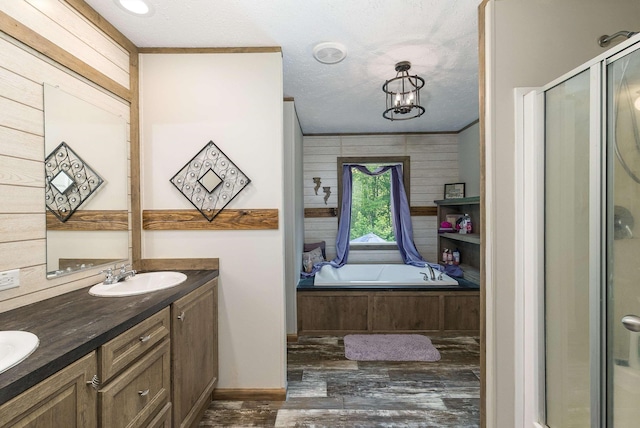 2749 Lee Hwy E, New Market, VA 22844 - bathroom with double vanity, a bath, a shower stall, a textured ceiling, and wood finished floors