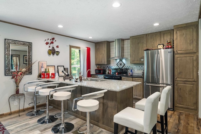 2749 Lee Hwy E, New Market, VA 22844 - kitchen featuring freestanding refrigerator, wall chimney exhaust hood, wood finished floors, tasteful backsplash, and black range with electric cooktop