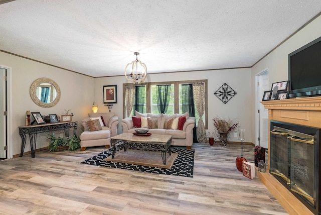 2749 Lee Hwy E, New Market, VA 22844 - living area with a glass covered fireplace, a chandelier, light wood-type flooring, crown molding, and a textured ceiling
