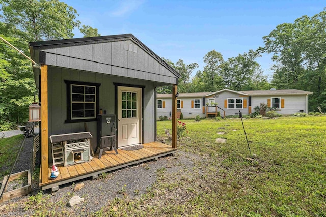2749 Lee Hwy E, New Market, VA 22844 - rear view of house featuring an outbuilding, a lawn, and board and batten siding