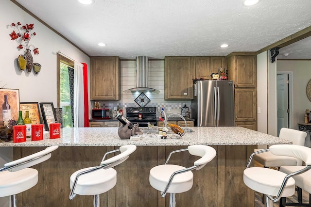 2749 Lee Hwy E, New Market, VA 22844 - kitchen featuring wall chimney range hood, freestanding refrigerator, black electric range oven, recessed lighting, and light stone countertops