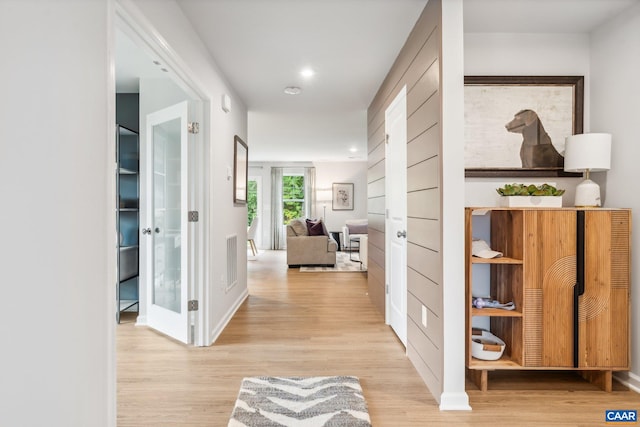 corridor with baseboards, recessed lighting, visible vents, and wood finished floors