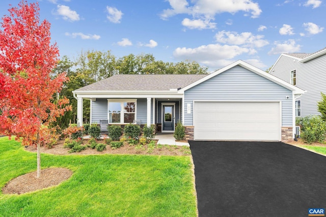 single story home with roof with shingles, stone siding, driveway, a garage, and a front yard