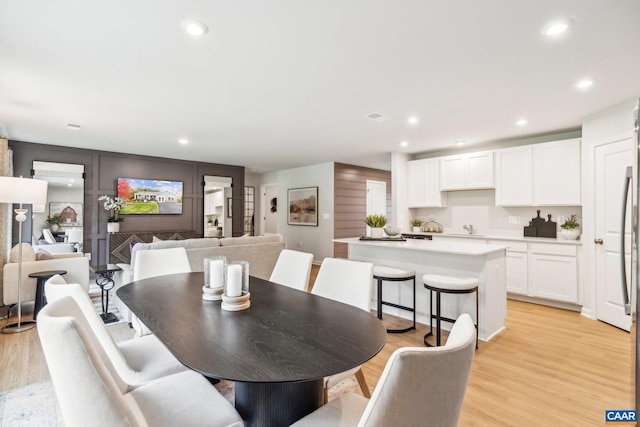 dining room featuring light wood-type flooring, visible vents, and recessed lighting