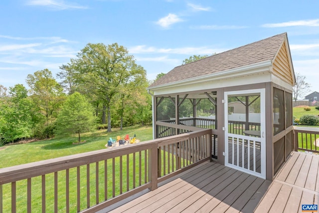 wooden deck featuring a sunroom and a lawn
