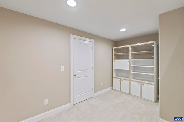 unfurnished bedroom with baseboards, light carpet, and recessed lighting