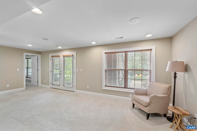 living area with recessed lighting, baseboards, and light carpet