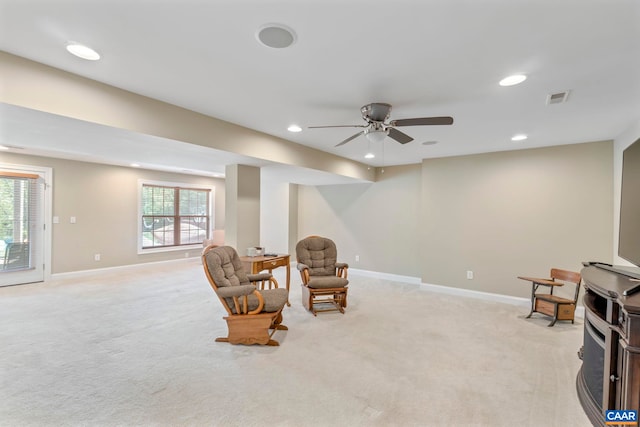 living area featuring light colored carpet, recessed lighting, ceiling fan, and baseboards