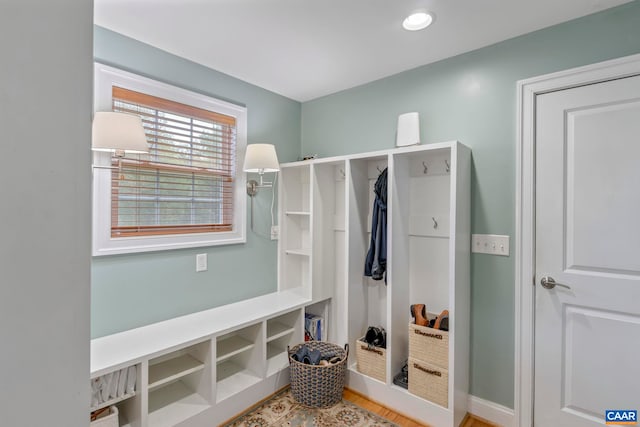 mudroom featuring wood finished floors and baseboards
