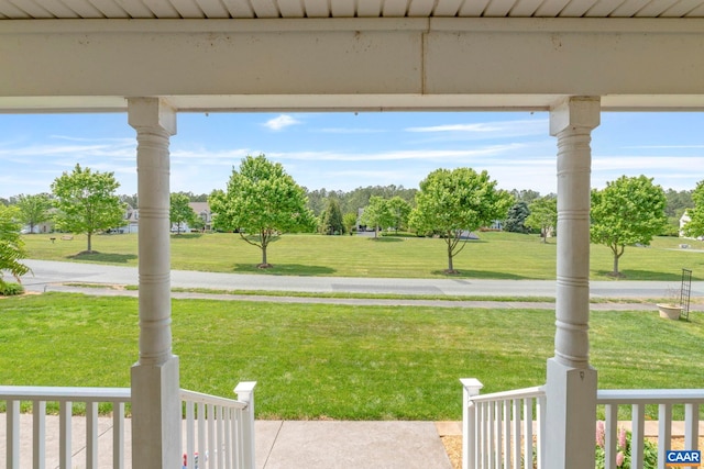 view of grassy yard with covered porch