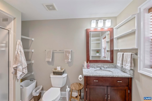full bathroom with a shower stall, toilet, and vanity