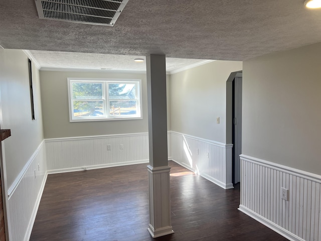 unfurnished room featuring dark hardwood / wood-style floors and a textured ceiling