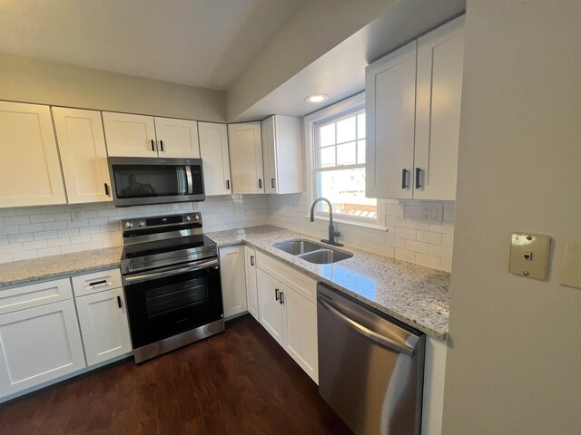 kitchen featuring stainless steel appliances, sink, and white cabinets