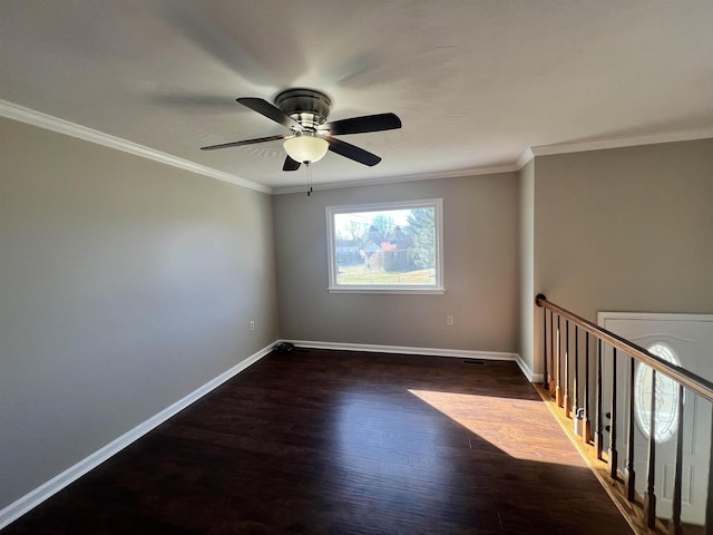 empty room featuring crown molding, dark hardwood / wood-style floors, and ceiling fan