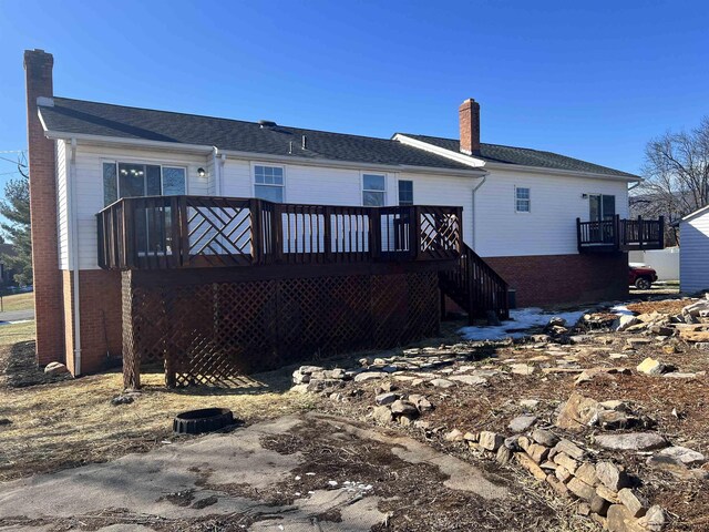 back of house featuring a wooden deck