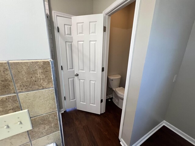 bathroom featuring wood-type flooring and toilet