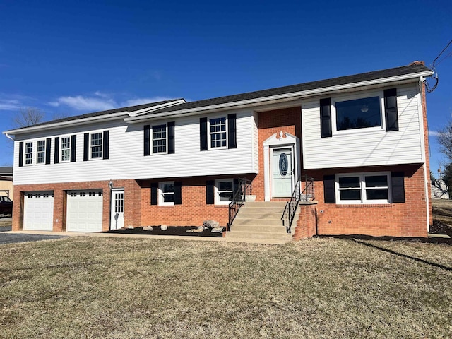 bi-level home with a garage and a front lawn