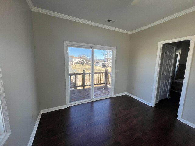 spare room featuring crown molding and dark wood-type flooring