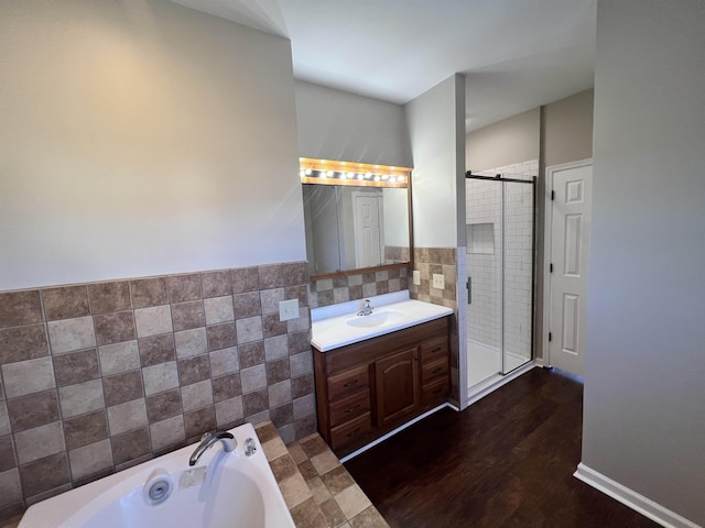 bathroom with tile walls, vanity, hardwood / wood-style flooring, and shower with separate bathtub