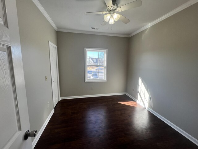 unfurnished room featuring crown molding, dark wood-type flooring, and ceiling fan