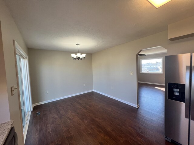 interior space with dark hardwood / wood-style floors and a notable chandelier