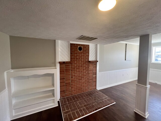 basement with dark hardwood / wood-style flooring and a textured ceiling