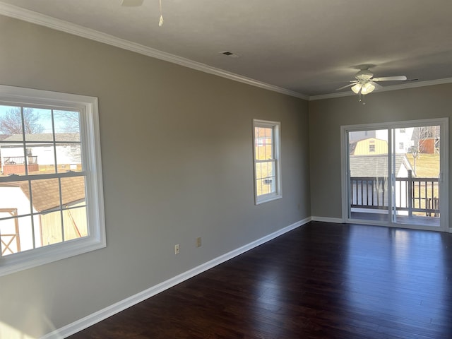 empty room with crown molding, ceiling fan, dark hardwood / wood-style floors, and a wealth of natural light