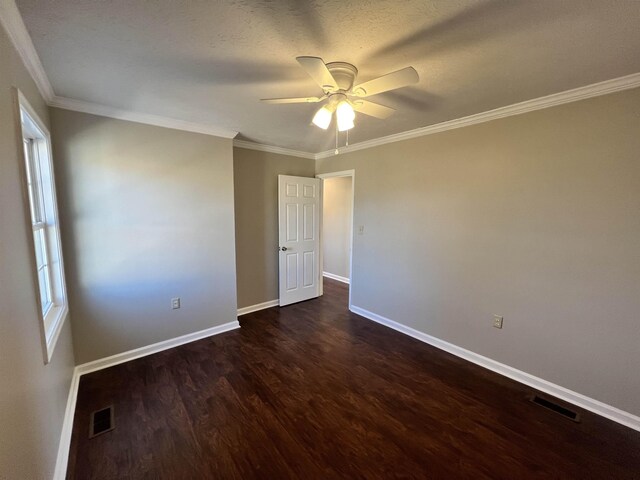 unfurnished room with dark hardwood / wood-style flooring, crown molding, plenty of natural light, and ceiling fan