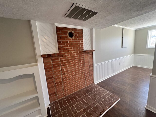 interior space featuring dark wood-type flooring and a textured ceiling