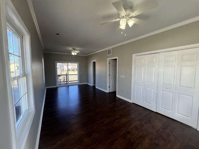 interior space featuring crown molding, dark wood-type flooring, ceiling fan, and a closet