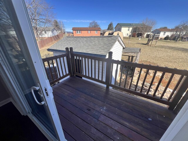 wooden deck featuring a playground