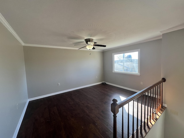 empty room featuring ceiling fan, ornamental molding, and dark hardwood / wood-style floors