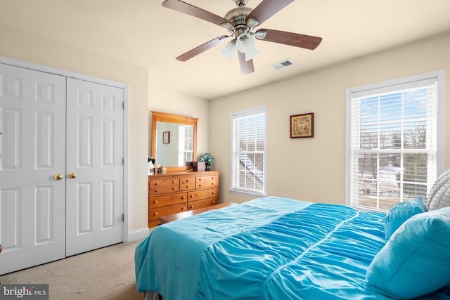 bedroom featuring carpet floors, a closet, and ceiling fan