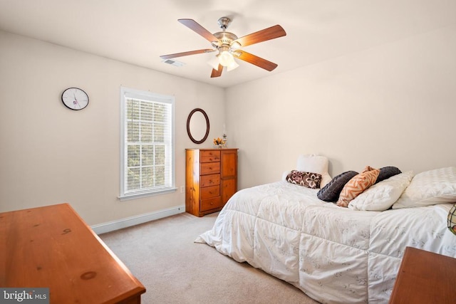 bedroom featuring light colored carpet and ceiling fan