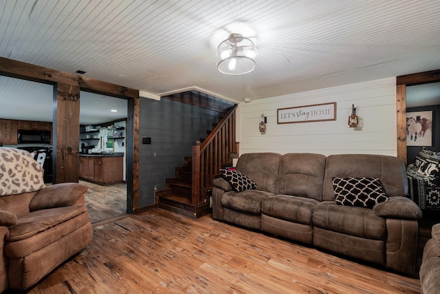 2420 Jollett Rd, Elkton, VA 22827 - living room with wood walls, stairway, and hardwood / wood-style flooring