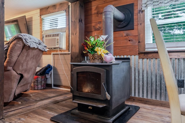 2420 Jollett Rd, Elkton, VA 22827 - detailed view of a wood stove, wood finished floors, cooling unit, baseboards, and wood walls