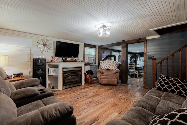 2420 Jollett Rd, Elkton, VA 22827 - living room with wooden walls, wood-type flooring, stairway, cooling unit, and a fireplace