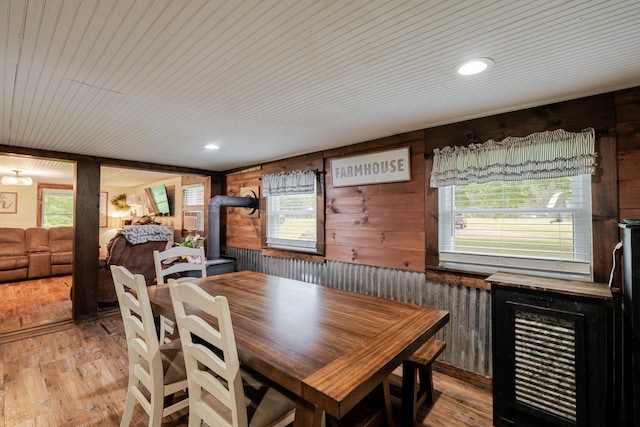 2420 Jollett Rd, Elkton, VA 22827 - dining room with wood walls, healthy amount of natural light, light wood-type flooring, a wood stove, and wooden ceiling