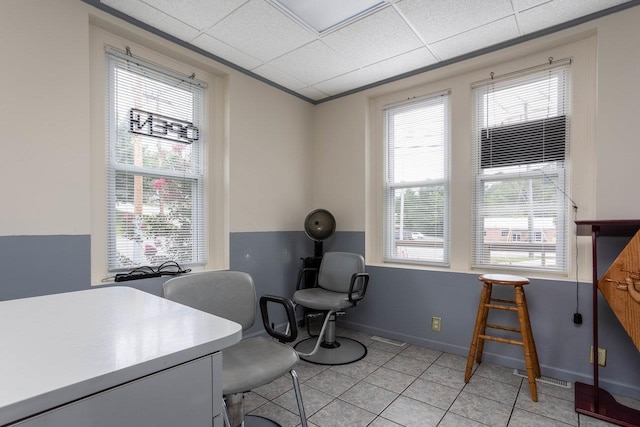 tiled home office featuring a drop ceiling