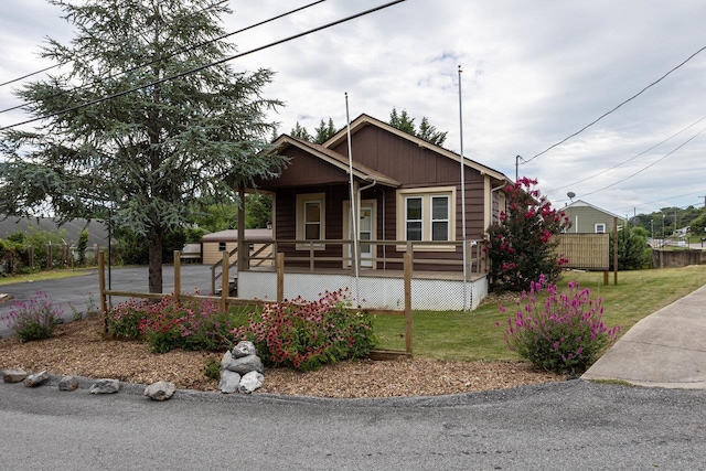 view of front of property with a front yard and covered porch