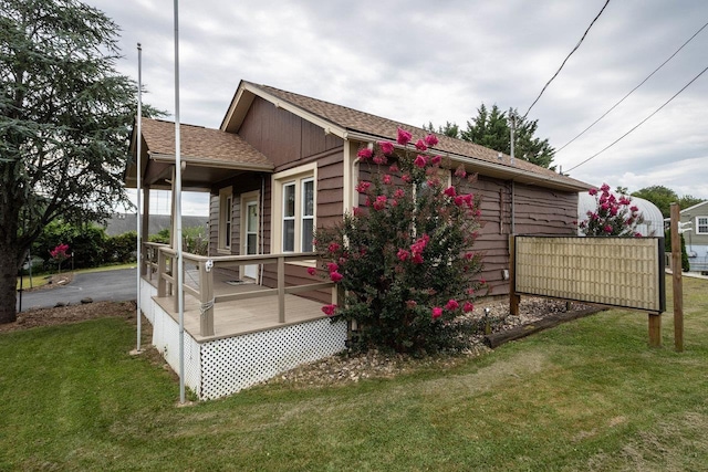 view of home's exterior featuring a porch and a lawn