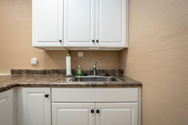 kitchen with white cabinetry and sink