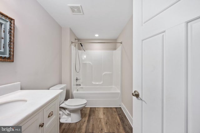 full bathroom with shower / tub combination, wood-type flooring, toilet, and vanity