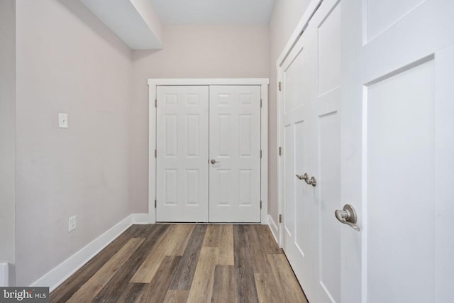 hallway with dark wood-type flooring