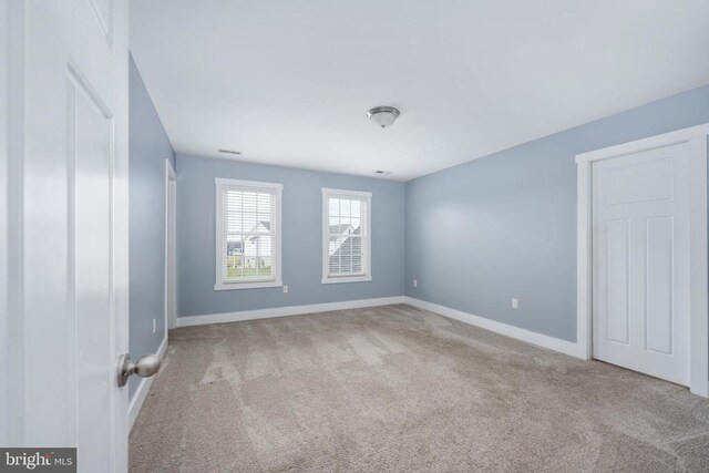 unfurnished bedroom featuring light carpet