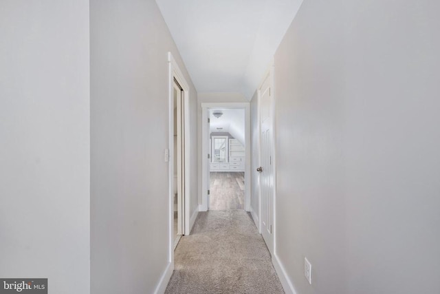 hallway featuring light colored carpet