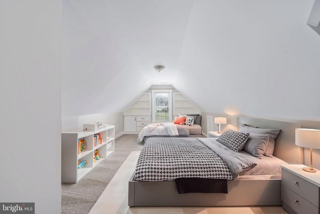 bedroom featuring lofted ceiling and light carpet